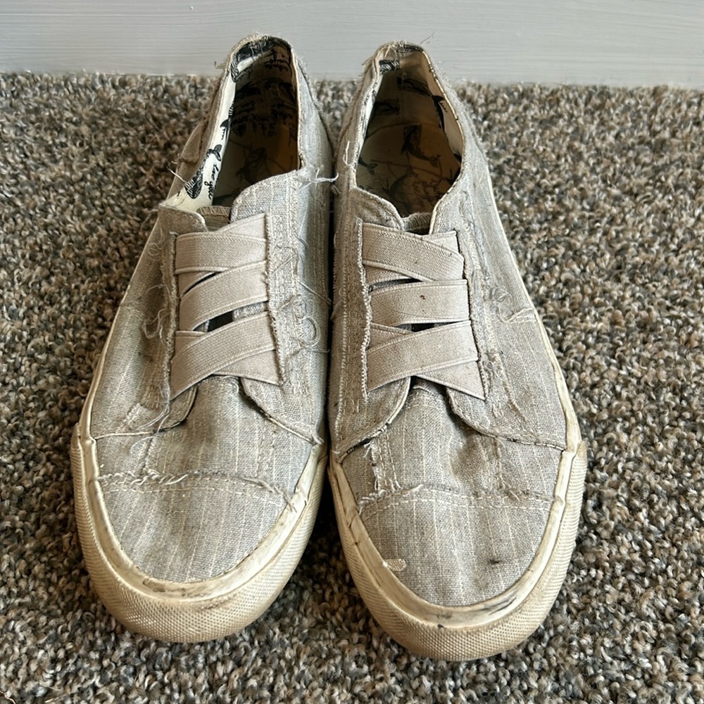 Very worn grey Blowfish shoes. Even have some paint on them.